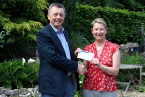 Rotarian Laurence Kettle presents the cheque to Kathy Miller 